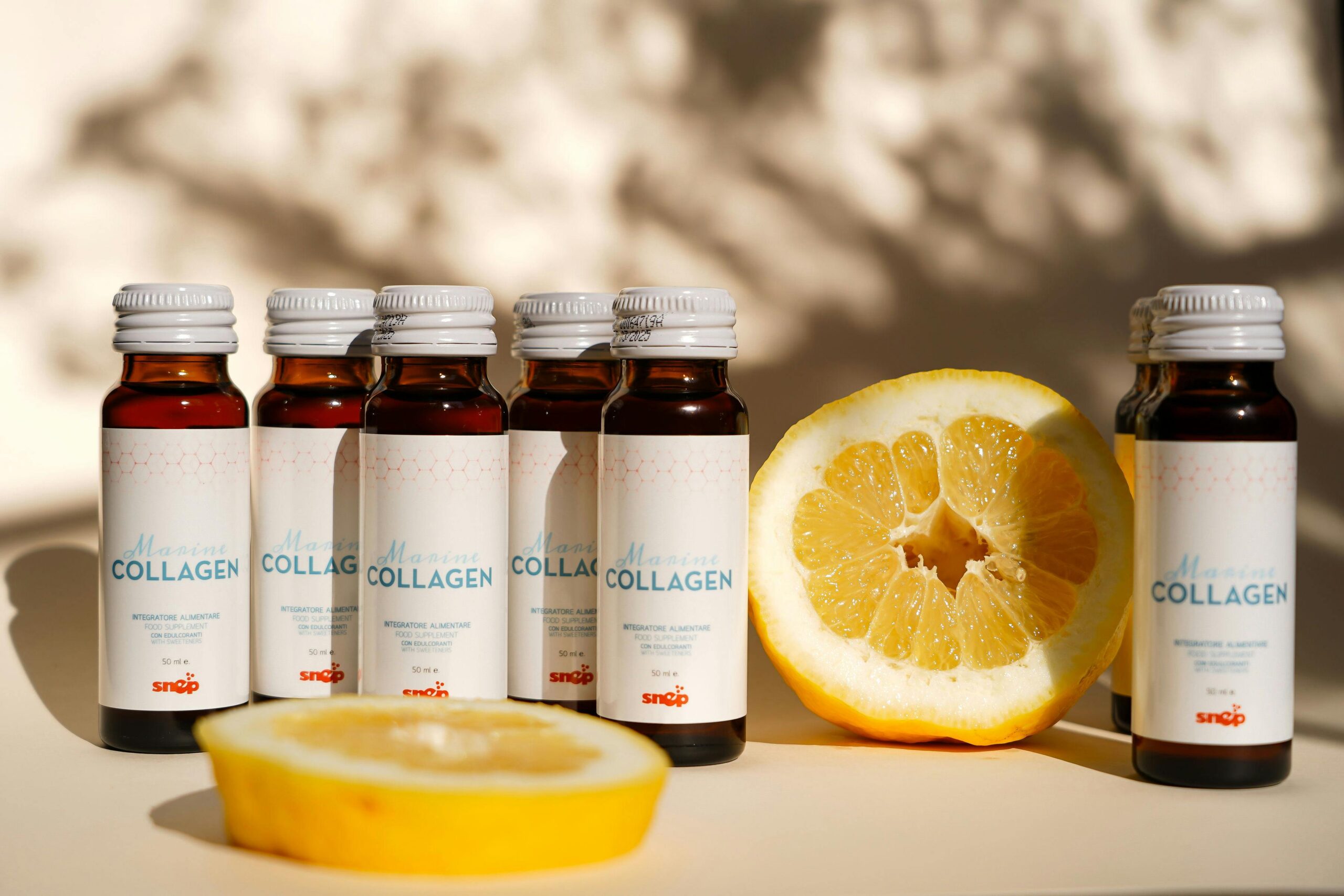 Collagen supplement bottles with lemon slice in bright light. Perfect for health and wellness themes.